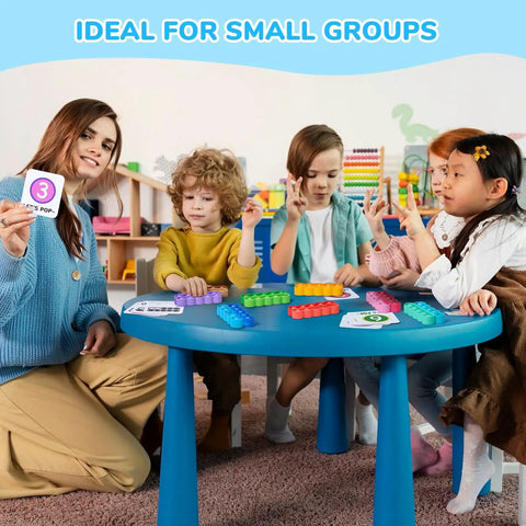 Children using Ten Frame Math Learning Kit With 24 Ten Frames And 20 Task Cards at a small blue table in a classroom setting.