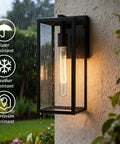 Lit Outdoor Wall Lantern Sconce 13.4 Inch Tall Anti Rust Metal Frame Weatherproof Exterior Light illuminated in rain on wall.