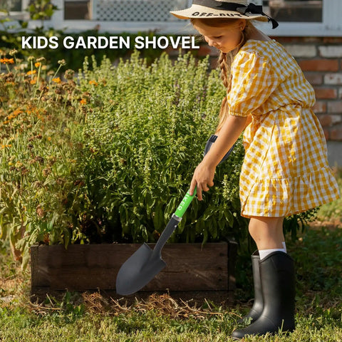 Child using Kids Beach Shovel For Digging And Gardening 28 Inch Metal Shovel With Short Handle Durable Green in a garden.