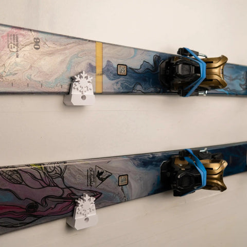 Slick Horizontal Ski Rack Wall Mount Bracket Black Hookless Design Keeps Your Boards Flat Against The Wall showcasing two pairs of skis.
