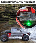 Beefed Up 7 Channel RC Transmitter With Waterproof Gyro Receiver shown with RC crawler near waterfall, highlighting splashproof feature.