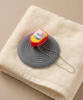 TEHAUX Silicone Bathtub Drain Stopper 6'', Hair Catcher for Bathroom, playful cartoon design on towel.