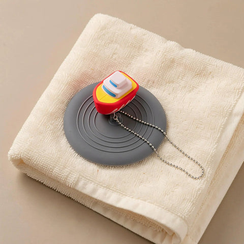 TEHAUX Silicone Bathtub Drain Stopper 6'', Hair Catcher for Bathroom, playful cartoon design on towel.