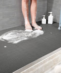 Game Changer Non Slip Drainage Flooring Rolls Custom Trim Down To Fit Pool Bathroom Garage Spa Warehouse Durable Water Resilient PVC Mats Thick Anti Fatigue Heavy Duty Commercial Grade Smooth Surface with feet on wet surface.