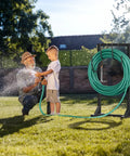 Beefy Freestanding Metal Hose Holder Stand With 4 Anchor Points And 6 Hooks Holds Up To 150 Feet Of Hose in a garden scene