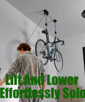 Ceiling Mount Bike Hoist With 100 Lb Capacity Overhead Storage For All Bike Types From E Bikes To Fat Tires Ideal Garage Or Workshop Space Saver Lift Your Ride Off The Floor And Free Up Cubic Footage shown in use lifting a bike with ease.
