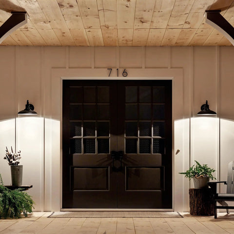 Allenbury 12 Inch One Light Outdoor Wall Light With Textured Black Finish lighting up double door entrance at night