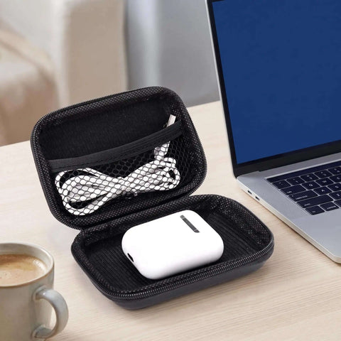 Black Hardshell Tech Travel Case For Cables And Chargers With Mesh Pocket And Elastic Straps Drip Proof Eva Cord Clutch For Smart Gadgets Everyday Carry Gear open with cables and earbuds inside.