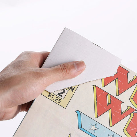 Hand holding adjustable cardboard corner protector on frame edge, demonstrating Adjustable Cardboard Corner Protectors For Shipping And Packing Edges Fits One Inch One And A Half Inch And Two Point One Inch Frames 40 Pack Reusable Thick Corrugated Cardboard Edge Protectors For Frames