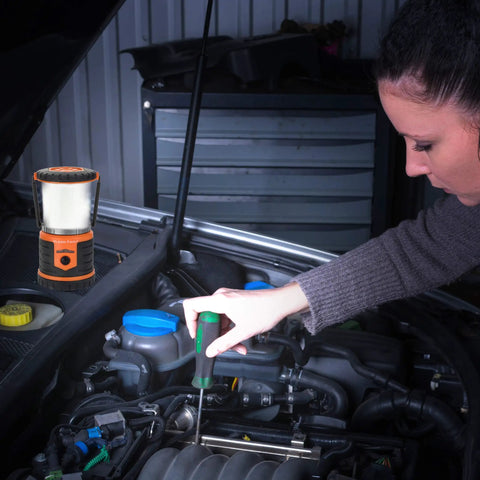 Woman repairing car engine at night with Tough As Nails Rugged USB Rechargeable Lantern with 12000mAh Power Bank Throws 1000 Lumens
