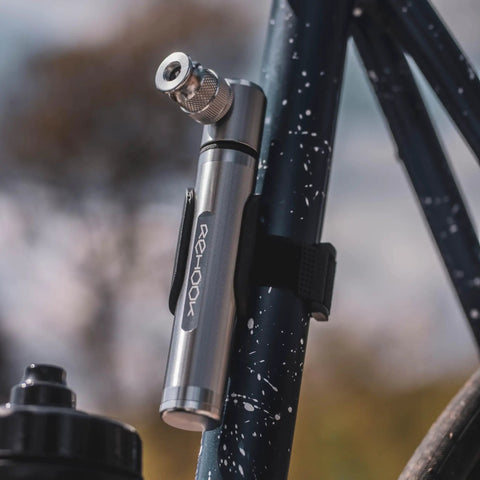 Emergency Bike Repair Kit With Lightweight Cycling Toolkit Includes Multitool Air Pump Tire Levers Glueless Puncture Patches And Quick On The Go Ride Ready Fixes For Roadside And Home Bike Maintenance - compact air pump attachment to bicycle frame close-up view