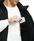 Close-up of man placing phone in pocket of Mens Fleece Lined Winter Vest Windproof Water Resistant Outerwear.
