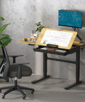Flexispot Electric Drafting Table With Adjustable Height And Tilting Top 47.2 By 23.6 Inches Extendable Workstation with drawings and storage drawer.