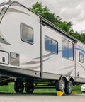 Curved Trailer Aid with Wheel Chock and Rubber Base Pad, Six and a Half Inch Lift, installed on a camper showing side view.