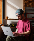 A man using a 2023 MacBook Pro Laptop Featuring Sick M2 Pro Specs And Smooth 16 Inch Retina XDR Screen 16GB Memory 1TB Fast Storage In Clean Space Gray.