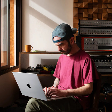 A man using a 2023 MacBook Pro Laptop Featuring Sick M2 Pro Specs And Smooth 16 Inch Retina XDR Screen 16GB Memory 1TB Fast Storage In Clean Space Gray.