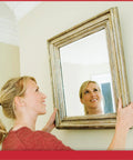 Woman using Picture Perfect Hanging System For Wall Art Up To Fifty Pounds No Wire Mount Kit to hang framed mirror flush on wall