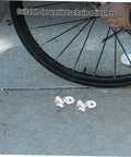 Adjustable Aluminum Alloy Bike Chain Tensioner Tool 2 Piece Set For Folding Bikes shown near bike wheel on pavement.