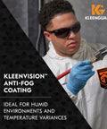 Worker wearing Kleenguard suit and V30 Nemesis Foam Safety Glasses With Anti Fog Lenses Black Frame Unisex Eyewear, using a spray gun.