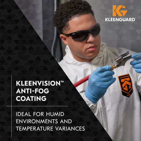 Worker wearing Kleenguard suit and V30 Nemesis Foam Safety Glasses With Anti Fog Lenses Black Frame Unisex Eyewear, using a spray gun.