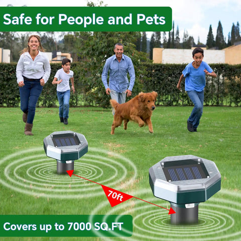 People and a dog enjoying the lawn with Solar Powered Ultrasonic Mole And Pest Repellent For Lawns And Gardens in foreground