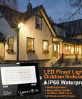 Outdoor RGB Flood Lights With 500W Equivalent Brightness Bluetooth App Control shown lighting a house facade, IP66 Waterproof.