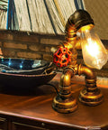 Steampunk Robot Pipe Desk Lamp With Vintage Industrial Edison Lighting, Bronze Metal Finish, Red Valve on wooden table