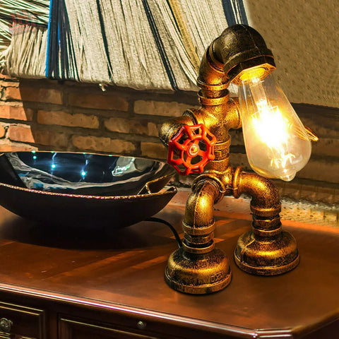 Steampunk Robot Pipe Desk Lamp With Vintage Industrial Edison Lighting, Bronze Metal Finish, Red Valve on wooden table