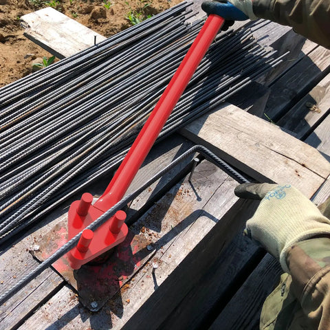 Heavy Duty Manual Rebar Bender For 5/8" Steel Bars in use, bending steel on a job site with gloves on.
