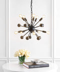 19.5-Inch Black 10-Light Iron Sputnik Chandelier, A Sleek Mid-Century Modern Industrial Ceiling Fixture With Adjustable Height For Dining Room Or Living Room, LED Bulbs Included, Easy Modern Upgrade, hanging over white table with flowers and book.