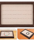 Solid Wood Earring Organizer And Ring Keeper Tray With Thirty Open Slots For Stashing Bracelets And Chains In A Rich Walnut Finish.