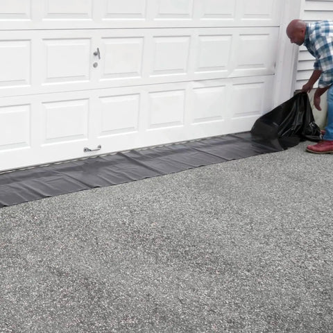 Reusable Water-Filled Flood Barrier Curb for Quick Home Flood Defense against a garage door, heavy-duty PVC, 6.5in by 10ft.