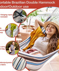 Relaxing in Single Person Brazilian Hammock With Carry Bag And Strong Ropes, Ultra Comfortable Cotton Polyester Fabric, stylish blue and green stripes, outdoor scene.