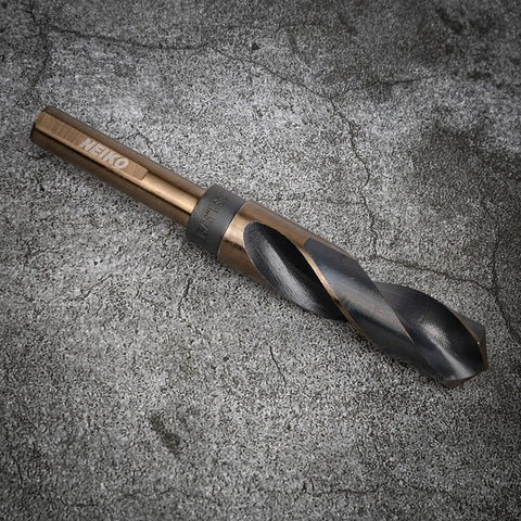 Close-up of a drill bit from the Beefy Heavy Duty Drill Bit Set For Drill Press With High Speed Steel One Half Inch Shank Eight Piece Pack Sizes Nine Sixteenths To One Inch Versatile For Plastic Copper Stainless Steel And More on concrete background.