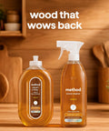 Daily Wood Cleaner Spray With Warm Almond Essence Knocks Out Stubborn Dust And Kitchen Grit While Skipping The Greasy Baggage Before It Sets In On Your Favorite Cabinetry And Hardwood - two bottles on a wooden countertop.