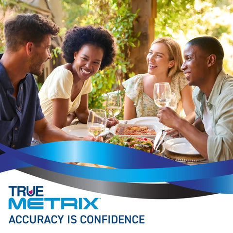 Group of friends enjoying a meal together outdoors with True Metrix advertisement overlayed.