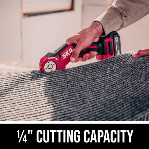 12V Compact Multi Cutter Tool Only with Self Sharpening Blade cutting carpet, displaying one-quarter inch cutting capacity.