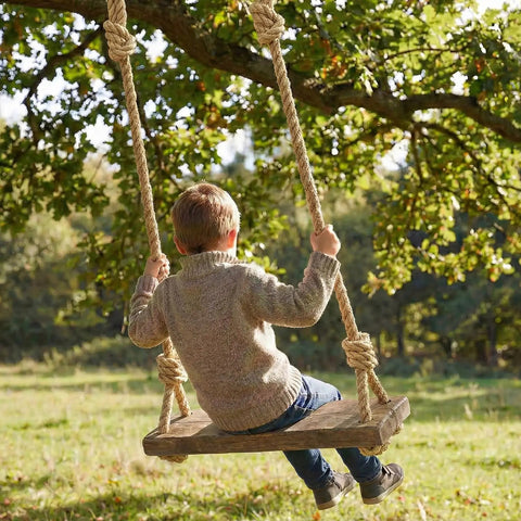 Child on a swing using Heavy Duty Workhorse Three Quarter Inch 100 Ft Natural Jute Rope For Nautical Decor Porch Swing Railing And Home Projects Braided Four Strand Hemp Style Cord Flexible Easy To Tie Knots 880 Lbs Safe Working Load Durable Natural Fiber outdoors