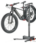 Electric Height Adjustable Bike Repair Stand With 100 Lb Capacity Hands Free Foot Lift Fast Ratchet Clamp holding an e-bike.