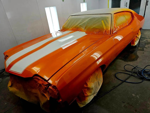 Showroom Smooth Dreamsicle Orange Basecoat Paint Gallon Ready To Spray Mix With Slow Reducer For Zero Hassle Street Car Restorations And Bumper To Bumper Shine on custom car in spray booth.