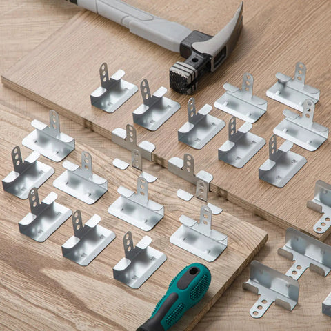 50 Pack Of 1/2 Inch Drywall Corner Repair Clips Featuring Top Shelf Wall Backup Fasteners For Studs laid out on a wooden surface with tools.