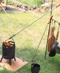 All Stainless Steel Grabber Reacher Pickup Tool Heavy Duty Trash Picker For Indoor Outdoor Use No Wire Patented Technology Delivers Extra Power And Strong Grip For Logs BBQ Pits Fireplace in use lifting grill from fire pit outdoors.