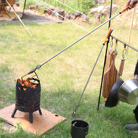 All Stainless Steel Grabber Reacher Pickup Tool Heavy Duty Trash Picker For Indoor Outdoor Use No Wire Patented Technology Delivers Extra Power And Strong Grip For Logs BBQ Pits Fireplace in use lifting grill from fire pit outdoors.