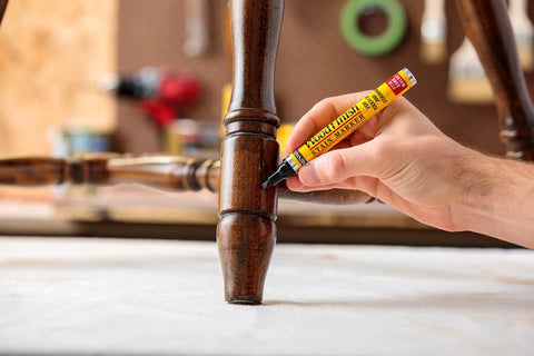 Person using Wood Finish Stain Marker For Easy No Fuss Touch Ups Provincial Shade Nicks And Scratches On Wood Furniture And Crafts