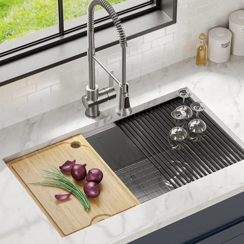 Solid Bamboo Cutting Board For Workstation Sinks Over The Sink Prep Board placed on ledge with sliced onions and herbs
