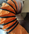 Heavy Duty Portable Dust Extractor Fan With Rock Solid Build And Killer Suction For Garage Workshops thick flexible orange hose section.