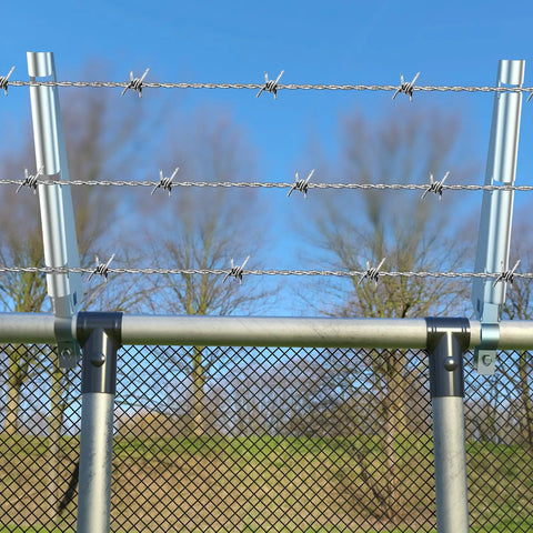 10 Pack Barbed Wire Arm For One And Three Eighths Inch Chain Link Fence Height Extender Galvanized Steel For Garden And Outdoor Fences Increase Height, Boost Privacy, And Keep Pets From Jumping DIY Friendly Install on a chain-link fence with trees in the background