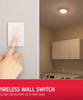 Hand pressing wireless wall switch with cordless LED ceiling light installed in a laundry room for remote control convenience.
