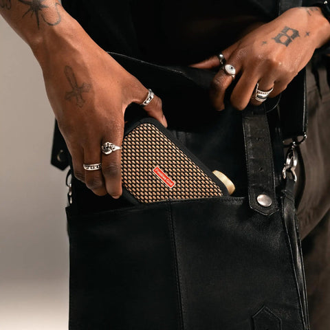 Ultra Portable 5W Smart Guitar Amp With Bluetooth Speaker Headphone Amp And Mobile App For Electric Acoustic Or Bass Guitars 33 Amps 43 Effects Custom Presets 50,000 ToneCloud Tones being placed in a black bag