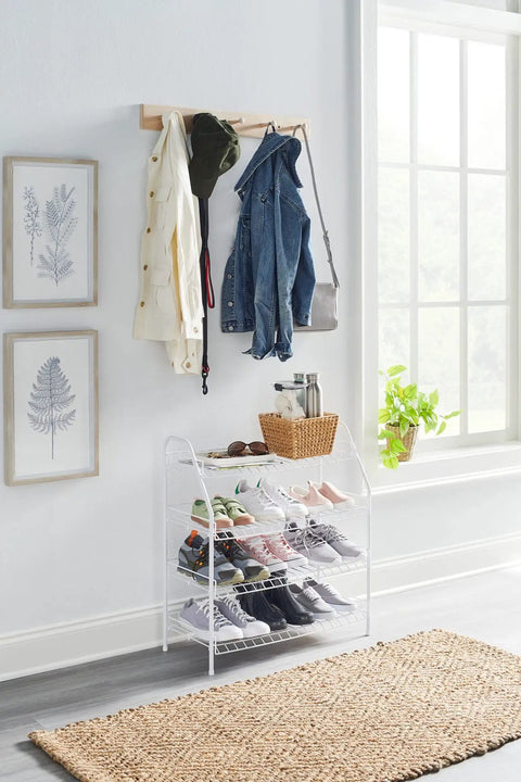 Four Tier Wire Shoe Rack White Simple Assembly Holds Up To 12 Pairs Of Shoes in bedroom with coats and decor visible